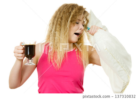 Tired woman drinking her morning coffee Tired woman drinking her morning coffee 137310832