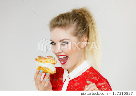 Funny woman holds cream puff cake 137310837