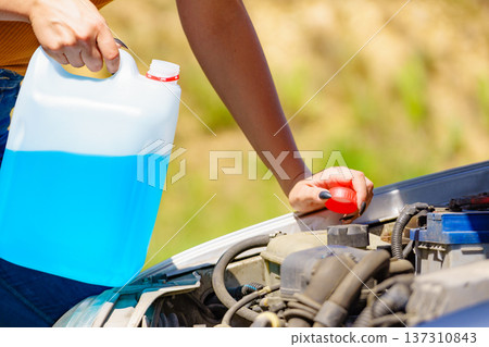 Pouring antifreeze liquid for washing car screen 137310843
