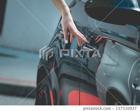 Fashionable woman opening car Fashionable woman opening car 137310937
