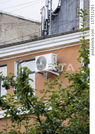 air conditioning on facade of building, air cooling in hot weather. air conditioning on facade of building, air cooling in hot weather. 137311261