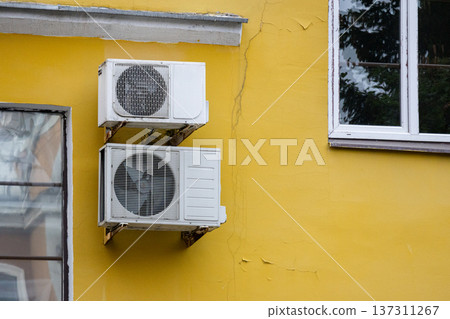 air conditioning on facade of building, air cooling in hot weather. air conditioning on facade of building, air cooling in hot weather. 137311267