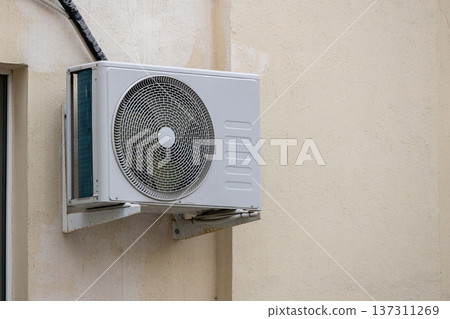 air conditioning on facade of building, air cooling in hot weather. air conditioning on facade of building, air cooling in hot weather. 137311269