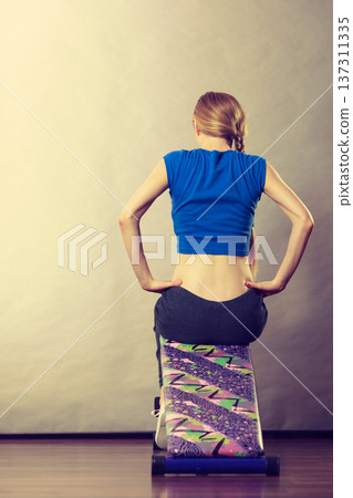 Woman training on bench for sit ups Woman training on bench for sit ups 137311335