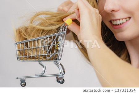 Girl with her long hair in shopping cart 137311354