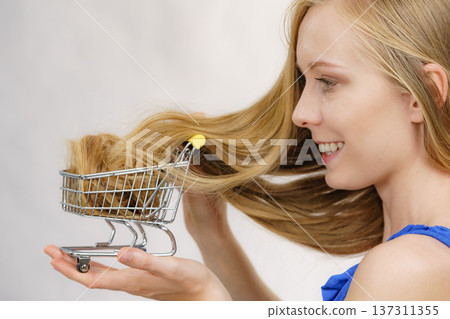 Girl with her long hair in shopping cart 137311355