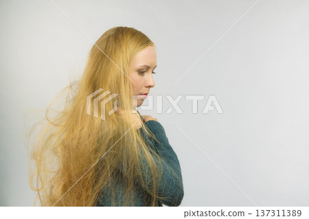 Sad girl with blowing hair 137311389