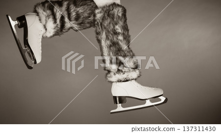 Woman legs wearing ice skates fur socks, skating Woman legs wearing ice skates fur socks, skating 137311430
