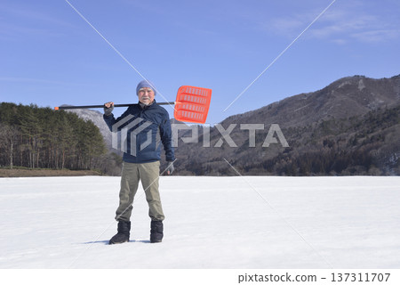 Snow removal for an elderly man living in a snowy country Snow removal for an elderly man living in a snowy country 137311707
