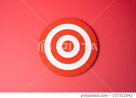 Target on a red background. Goal concept. Career and life aspirations. Marketing and advertising. Strategic planning and success mindset symbolizing ambition focus branding campaign Target on a red background. Goal concept. Career and life aspirations. Marketing and advertising. Strategic planning and success mindset symbolizing ambition focus branding campaign 137312042