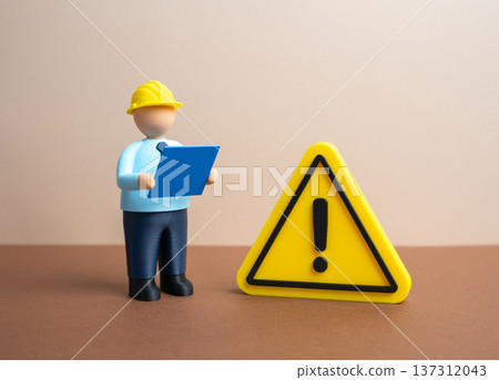 An engineer wearing a helmet and holding blueprints examines a problem. A technological problem and the search for a technical solution. Building code inspection An engineer wearing a helmet and holding blueprints examines a problem. A technological problem and the search for a technical solution. Building code inspection 137312043