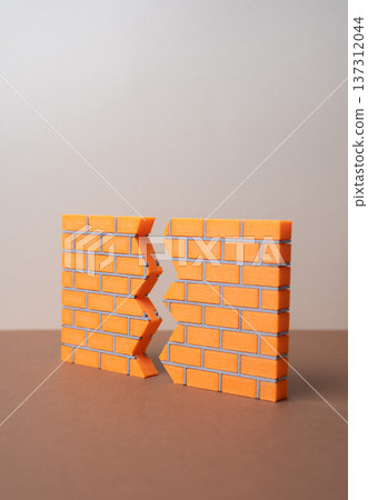 A crack in the brick wall. A breakthrough concept in problem solving, cracking secrets. The first steps toward compromise and reconciliation. Overcoming barriers and conflict resolution symbol A crack in the brick wall. A breakthrough concept in problem solving, cracking secrets. The first steps toward compromise and reconciliation. Overcoming barriers and conflict resolution symbol 137312044