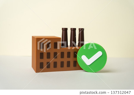 A factory with a green checkmark. The industrial plant has passed the inspection. Environmental standards are met. Sustainable production and eco compliance certification in manufacturing sector A factory with a green checkmark. The industrial plant has passed the inspection. Environmental standards are met. Sustainable production and eco compliance certification in manufacturing sector 137312047