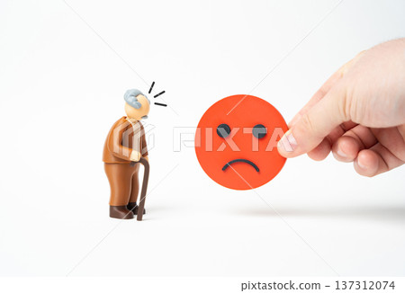 An elderly man and a sad face symbol. Social problems and request denial reflecting public opinion research feedback analysis and dissatisfaction among seniors. 137312074