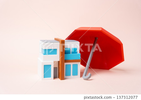 A modern residential building under the umbrella of insurance. Housing protection from damage accidents and legal risks with property insurance and risk management solutions. 137312077