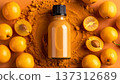 A bottle of lucuma extract sits in the center. Whole lucuma fruits surround the bottle on an orange surface. Lucuma powder is scattered around, highlighting the fruit. 137312689