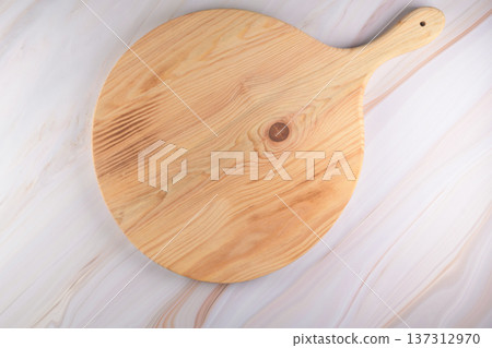 Wooden cutting board on a gray marble background Wooden cutting board on a gray marble background 137312970