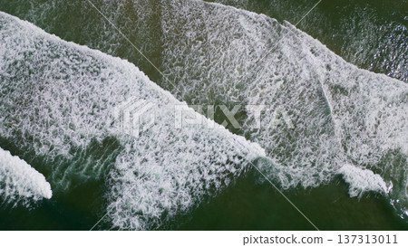 Overhead view of waves crashing on sandy beach Overhead view of waves crashing on sandy beach 137313011