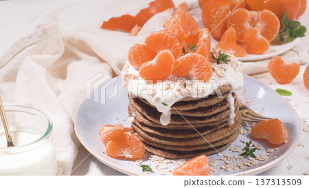 Pancakes with yogurt and tangerines Pancakes with yogurt and tangerines 137313509