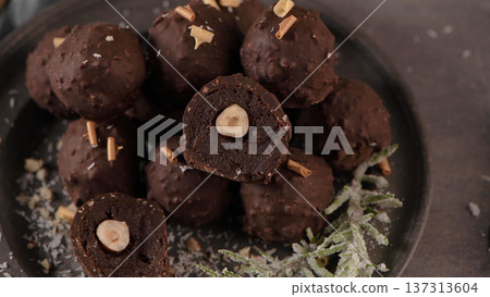 Dark chocolate truffles with hazelnuts Dark chocolate truffles with hazelnuts 137313604