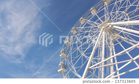 White ferris wheel against a clear blue sky White ferris wheel against a clear blue sky 137313605
