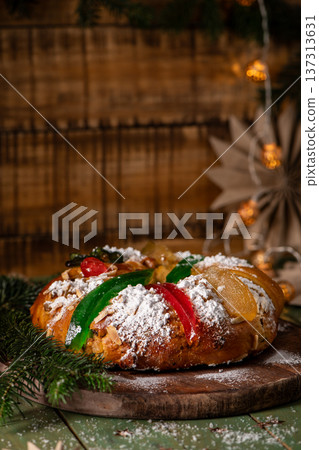 A festive King Cake adorned with colorful candied fruits 137313631