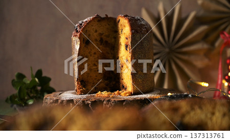 Horizontal Still Life of Sliced Panettone on Rustic Wood with Warm Background Lights 137313761