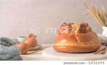 Sweet Braided Brioche Bread with Eggs and Cinnamon on Marble Board 137313775