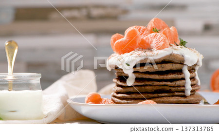 Stack of Buckwheat Pancakes Topped with Yogurt Cream and Fresh Mandarin Orange Segments Stack of Buckwheat Pancakes Topped with Yogurt Cream and Fresh Mandarin Orange Segments 137313785