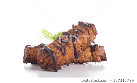 Baked Granola Bars Drizzled with Dark Chocolate and Mint Garnish 137313789
