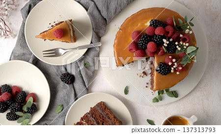 Top View of Gourmet Chocolate Cake Topped with Caramel Glaze and Fresh Berries 137313793