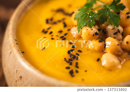Creamy Pumpkin Soup Garnish with Chickpeas and Black Sesame Seeds 137313802