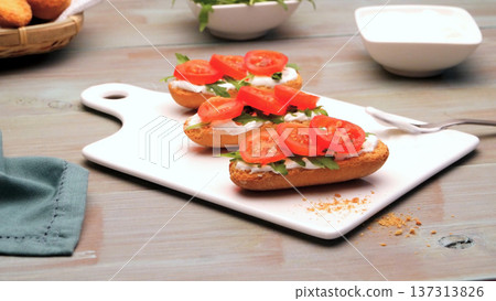 Bruschetta with Fresh Tomato and Cream Cheese on a White Serving Board Bruschetta with Fresh Tomato and Cream Cheese on a White Serving Board 137313826