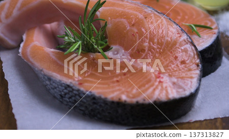 Fresh Raw Salmon Steak with Rosemary and Spices on Parchment Paper 137313827