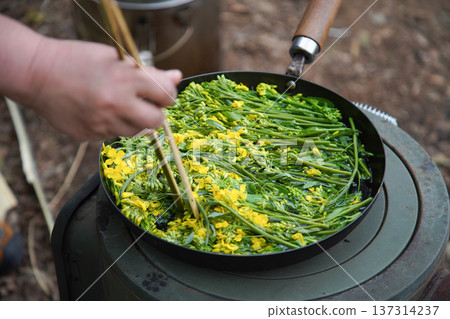A woman boiling rape blossoms A woman boiling rape blossoms 137314237