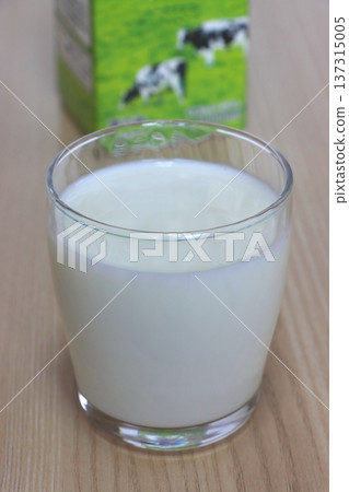 Milk in a glass and a milk carton (vertical composition) 137315005
