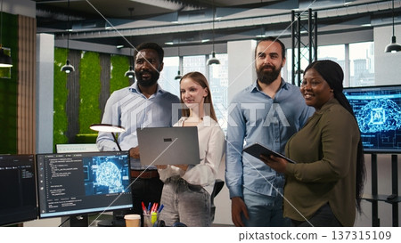Team of programmers in office automating repetitive tasks using AI scripts on devices. Teamworking IT experts brainstorming, using artificial intelligence to speed up feature implementation, camera A 137315109