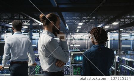 Data center manager overseeing work done by admin using neural network AI LLM visualization. Server farm team leader and worker overseeing rigs powering machine learning processes, Data center manager overseeing work done by admin using neural network AI LLM visualization. Server farm team leader and worker overseeing rigs powering machine learning processes, 137315134