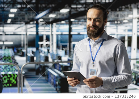 Data center admin doing infrastructure AI deep learning automatization, working on elevated industrial platform. Data scientist maintaining server rigs using artificial intelligence. 137315246
