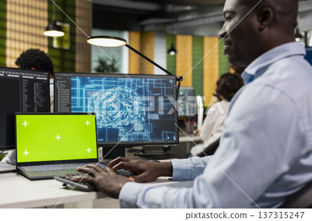 Chroma key laptop used by developer in AI tech company workplace to conduct code reviews. IT specialist using mockup notebook at office desk to design and implement machine learning algorithms 137315247