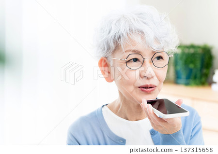 Senior woman talking to a smartphone Senior woman talking to a smartphone 137315658