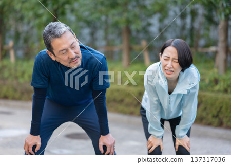 Men and women exercising and sweating Men and women exercising and sweating 137317036