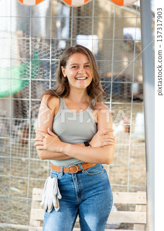 Young woman posing at chicken farm 137317903
