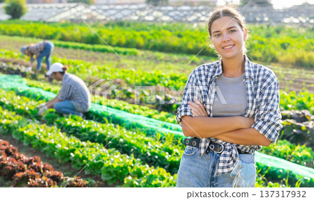 Young woman posing in field among harvest Young woman posing in field among harvest 137317932