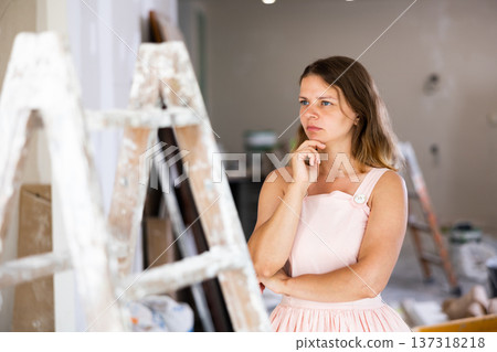 Portrait of thoughful young woman in construction site 137318218