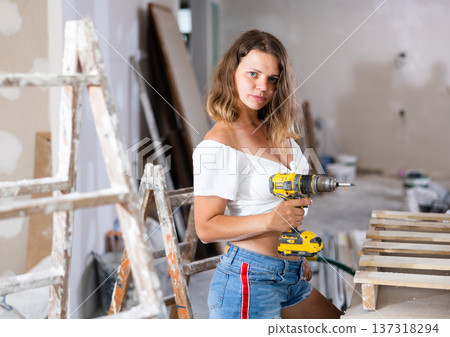 Portrait of attractive woman with drill Portrait of attractive woman with drill 137318294