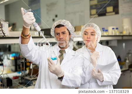 Confident man technician working in research laboratory Confident man technician working in research laboratory 137318329