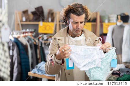 Man search and choose ladys lace panties in store 137318345