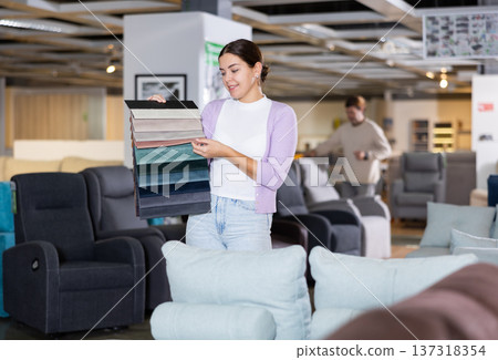 girl imagines how sofa will look in chosen upholstery or cover girl imagines how sofa will look in chosen upholstery or cover 137318354