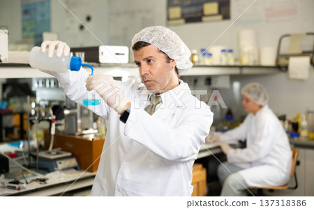 Portrait of an adult male using equipment to work in a laboratory Portrait of an adult male using equipment to work in a laboratory 137318386
